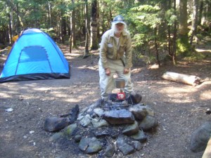 Man cooking over campfire