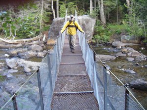 Man crossing metal bridge