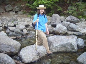Woman crossing rocky stream